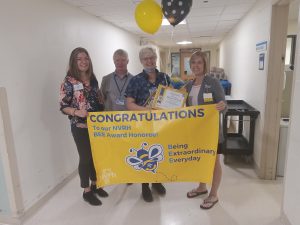 NVRH COO Laura Newell, CFO Andre Bissonnette, and Project Coordinator Tori Guibord surround nominee Marcia Therrian (holding balloons), who received numerous nominations.