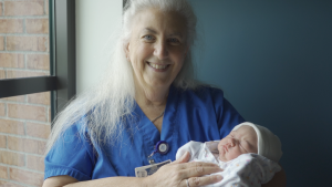 NVRH CNM Jade Kaplan holds a newborn.